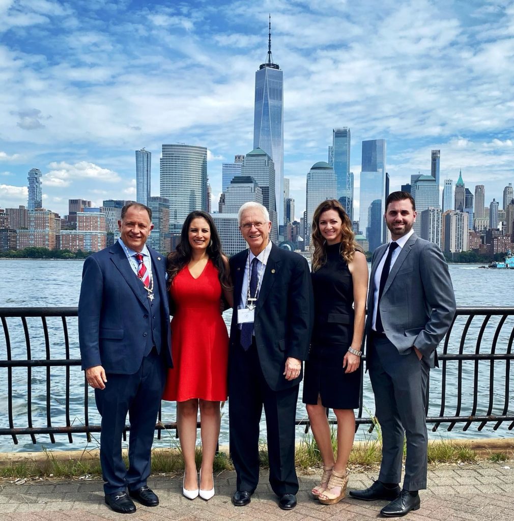 Group of people standing behind buildings