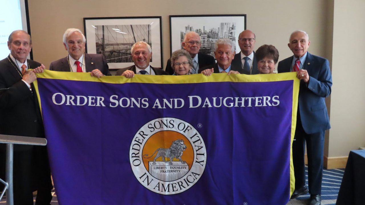 Group of people holding flag of there organization